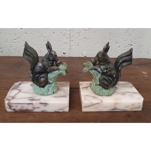 323 - A good pair of Bookends depicting Squirrels taking nuts on marble bases. H 12 cm approx.  Sold due t... 
