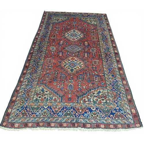 211 - A Terracotta ground hand woven 100% wall pile Persian Ardabil Carpet. 152 x 308 cm approx.