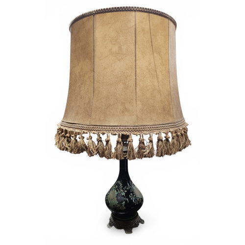 225 - An early 20th Century ebonised Ceramic bulbous table Lamp with hand painted floral decoration, on a ... 