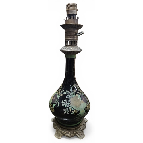 225 - An early 20th Century ebonised Ceramic bulbous table Lamp with hand painted floral decoration, on a ... 