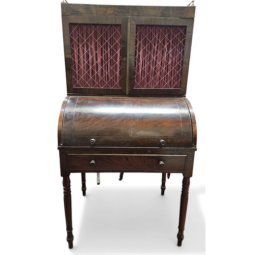 447 - A Regency Mahogany Cylinder Desk on turned supports with twin door gallery top. 78 x 54 x H 152 cm a... 