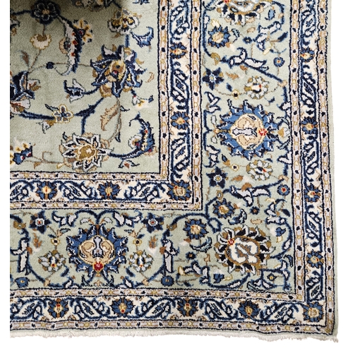 221 - A large duck egg blue ground Persian Carpet with repeating borders and floral medallion design.
 L 3... 