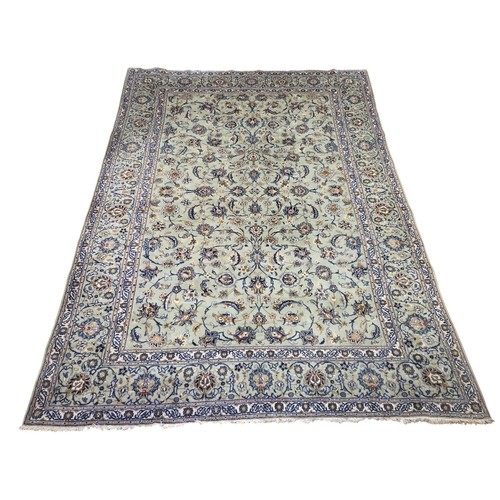 221 - A large duck egg blue ground Persian Carpet with repeating borders and floral medallion design.
 L 3... 