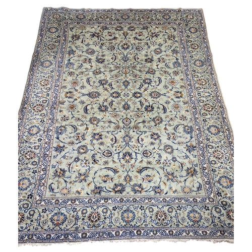 221 - A large duck egg blue ground Persian Carpet with repeating borders and floral medallion design.
 L 3... 