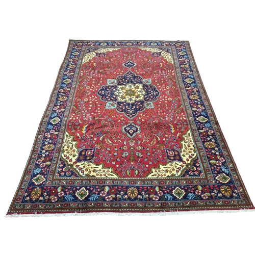 438 - A multicoloured ground fine hand woven Persian Tabriz Carpet. 246 x 348 cm approx.