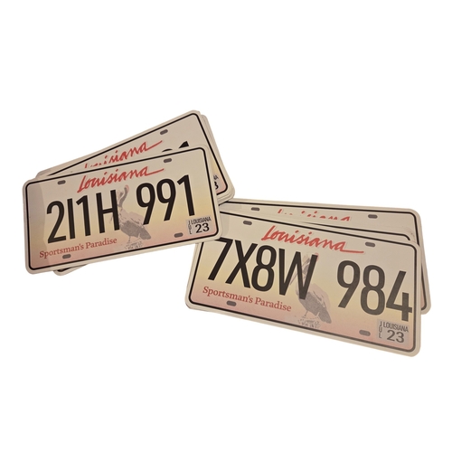 30 - A box of Prop Items to include Louisiana Number Plates.