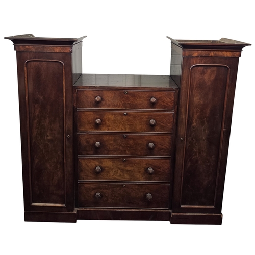 15 - A 19th Century Mahogany Sentry Box Wardrobe consisting of a bank of four graduated drawers flanked b... 