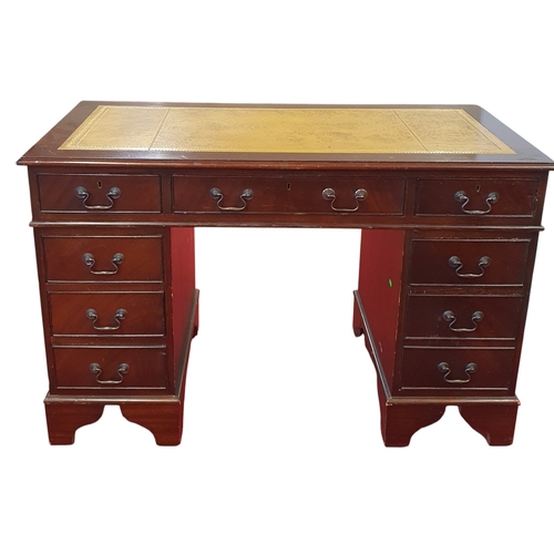 44 - A reproduction Mahogany and Veneered Desk with cream leather top.  W 121 x D 61 x H 78 cm approx.