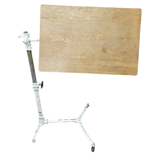 783 - A 19th Century Cast Iron adjustable Work Table with timber panelled table top.
H 105 cm approx.