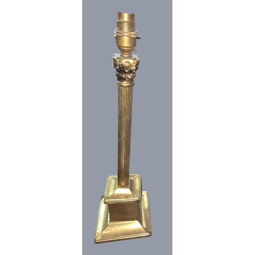 785 - A quantity of Aladdin oil lamp Chimneys along with a Brass table lamp. H 44 cm approx.