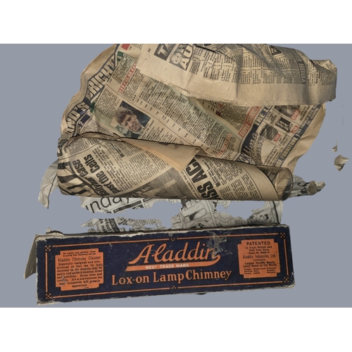785 - A quantity of Aladdin oil lamp Chimneys along with a Brass table lamp. H 44 cm approx.