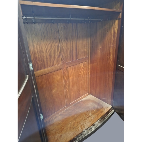 766 - An early 20th Century Mahogany three door Wardrobe with mirrored centre and serpentine outline.
W 17... 