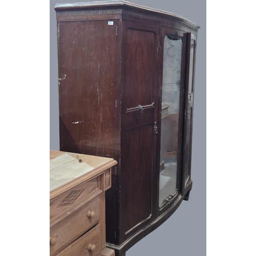 766 - An early 20th Century Mahogany three door Wardrobe with mirrored centre and serpentine outline.
W 17... 