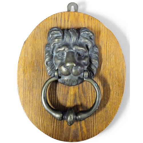 3 - A really good Brass Door Knocker mounted on an Oak plaque. 29 x 24 cm approx.