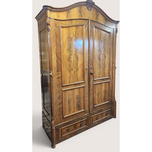 27 - A good 19th Century Mahogany two door Continental Wardrobe with Mahogany flame grain panel doors ove... 