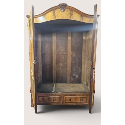 27 - A good 19th Century Mahogany two door Continental Wardrobe with Mahogany flame grain panel doors ove... 