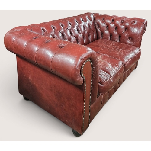 31 - An Ox Blood Leather deep buttoned Chesterfield two seater Sofa. W 150 x SH 37 x BH 66 cm approx.