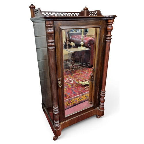21 - A late 19th early 20th Century Mahogany Side Cabinet with a mirrored panel door on turned fluted sup... 