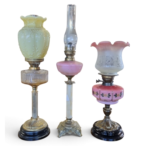 48 - A group of three 19th early 20th Century Oil Lamps with one converted. TB 68 cm approx.