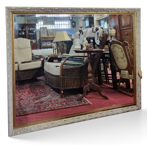 13 - An extremely large painted rectangular Mirror with highly moulded outline and bevelled mirrror glass... 