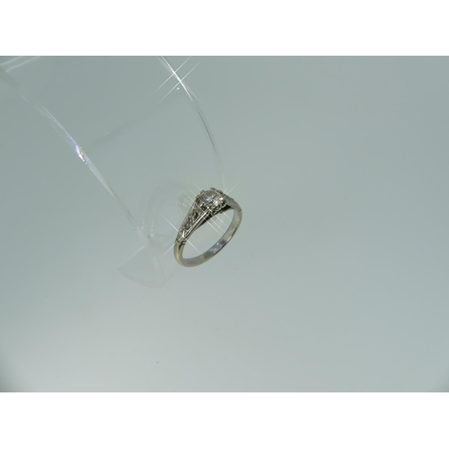 104 - A solitaire diamond Ring, the facetted diamond c.0.4ct, the shaped shoulders each set with two small... 