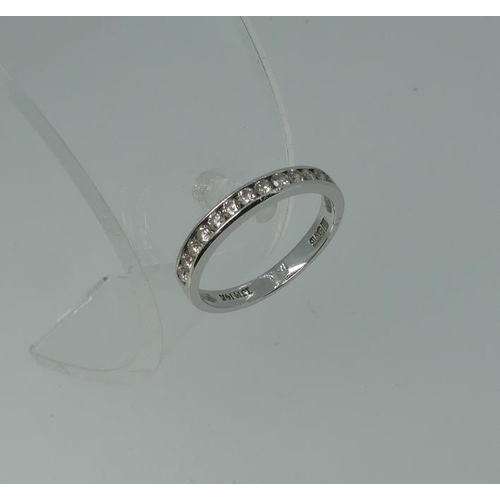 107 - A diamond set half hoop Eternity Ring, the front with twelve channel set diamonds, c.0.33cts total, ... 