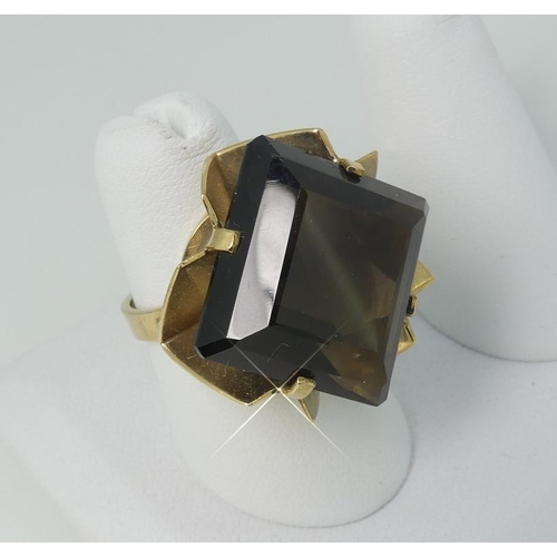 120 - A 9ct yellow gold Dress Ring, the front set diagonally with a large square smokey quartz within a pi... 