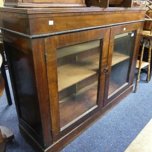 134 - A 19th century mahogany Bookcase, the pair of glazed doors enclosing shelves, 46¼in (117.5cm) wide.