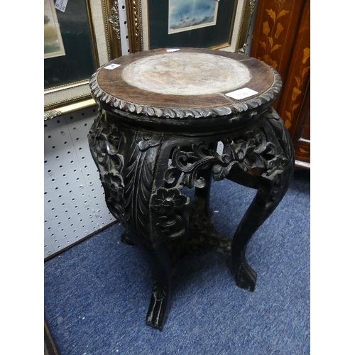 136 - A 19thC oriental ebonised hardwood Plant Stand,carved with floral and foliate decoration, the circul... 