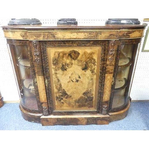 138 - A Victorian figured walnut and inlaid Credenza, with gilt metal mounts, the shaped top above central... 