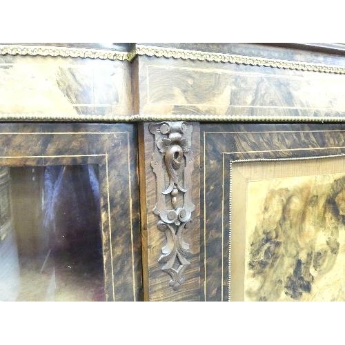 138 - A Victorian figured walnut and inlaid Credenza, with gilt metal mounts, the shaped top above central... 