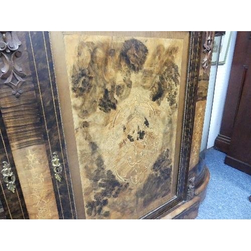 138 - A Victorian figured walnut and inlaid Credenza, with gilt metal mounts, the shaped top above central... 