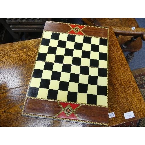 160 - A decorative inlaid folding Chess Board, with compartments containing ebony and boxwood chess pieces... 