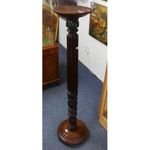 162 - A Victorian mahogany Torchère/ Plant-stand, with reeded and carved column on circular base raised on... 