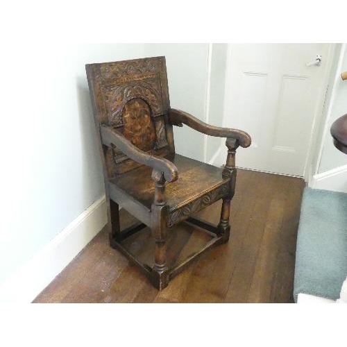 167 - An antique carved oak Wainscot Chair, the arched panelled back with floral marquetry decoration, scr... 