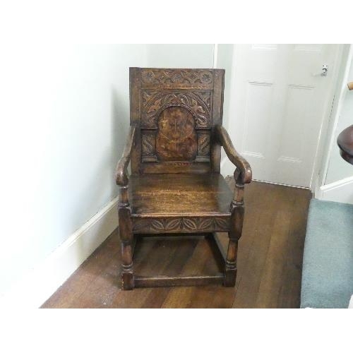 167 - An antique carved oak Wainscot Chair, the arched panelled back with floral marquetry decoration, scr... 