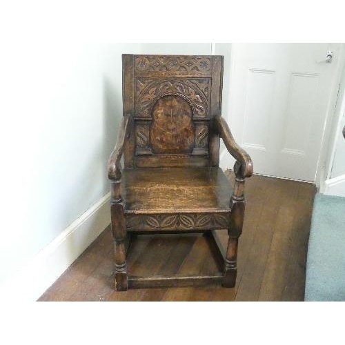 167 - An antique carved oak Wainscot Chair, the arched panelled back with floral marquetry decoration, scr... 