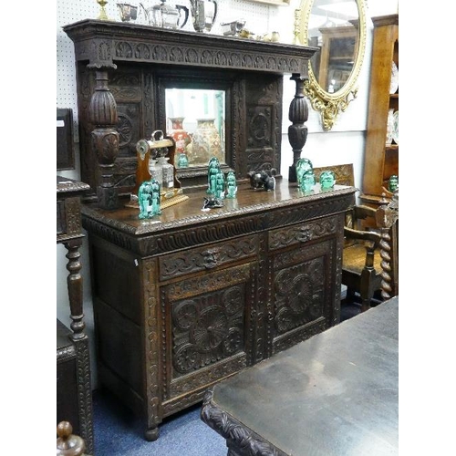 173 - A late Victorian carved oak mirror-back Sideboard, the raised back with bulbous supports above two d... 