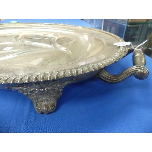 181 - A silver-plated oval Meat Warming Serving Platter, two-handled with foliate gadrooned edge on scroll... 