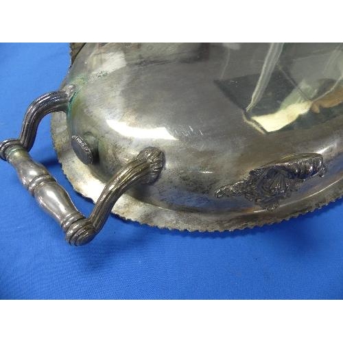 181 - A silver-plated oval Meat Warming Serving Platter, two-handled with foliate gadrooned edge on scroll... 