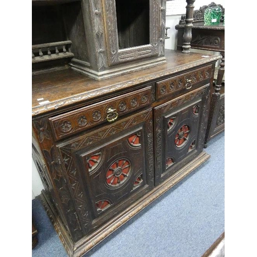 182 - A late Victorian carved oak Sideboard, with spindle and wheel panels, the break-front upper section ... 