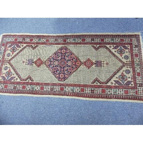 212 - Tribal Rugs; an antique Serab runner, the light beige ground woven with central diamond shaped medal... 