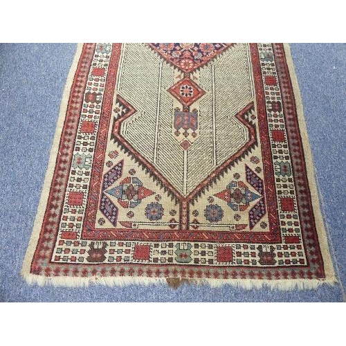 212 - Tribal Rugs; an antique Serab runner, the light beige ground woven with central diamond shaped medal... 