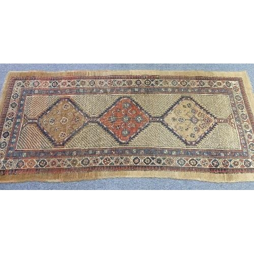 213 - Tribal Rugs; an antique Serab runner, the light beige ground woven with three conjoined diamond shap... 