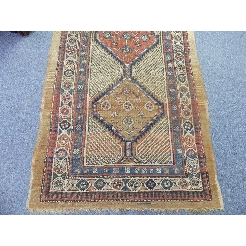 213 - Tribal Rugs; an antique Serab runner, the light beige ground woven with three conjoined diamond shap... 