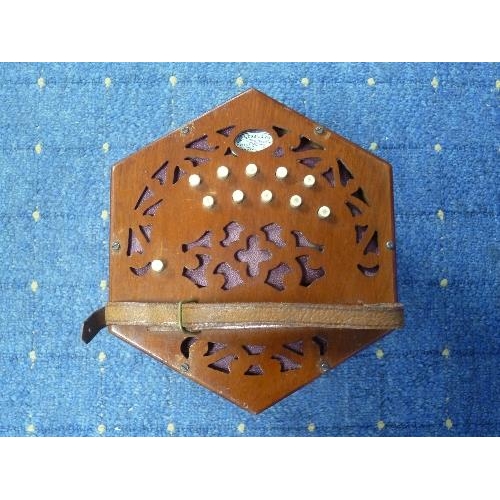 228 - A Patent Concertina by Lachenal & Co., twenty-one buttons, fretted wood ends and manufacturers label... 