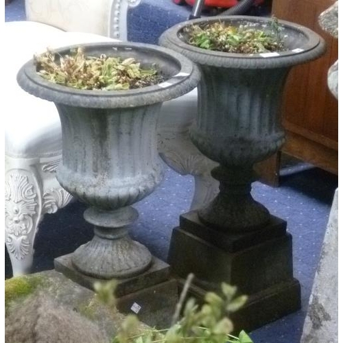 250 - Garden statuary: a pair of cast iron classical-style Urns on Plinths, one urn with cracked rim,  tot... 