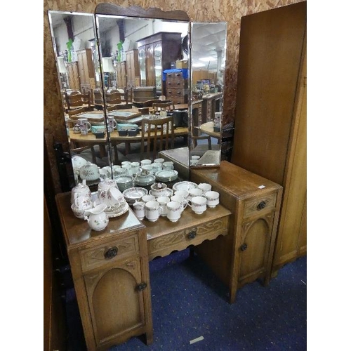 302 - A 1930's oak Bedroom Suite, comprising Triple and Double Wardrobes, Dressing Table, 4'6