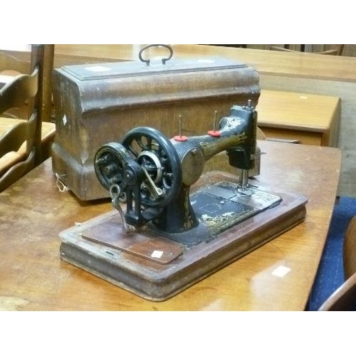 307 - A Frister and Rossmann dome cased Sewing Machine, together with a vintage sewing box and bag, a part... 