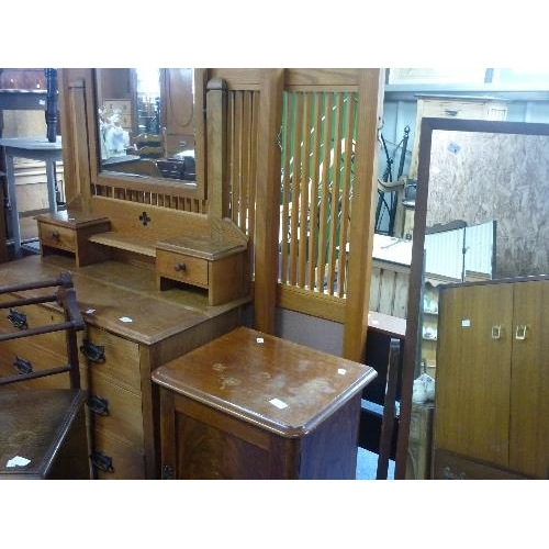 322 - An early 20thC oak Dressing Table, in the Arts and Crafts style, with swing mirror above three long ... 